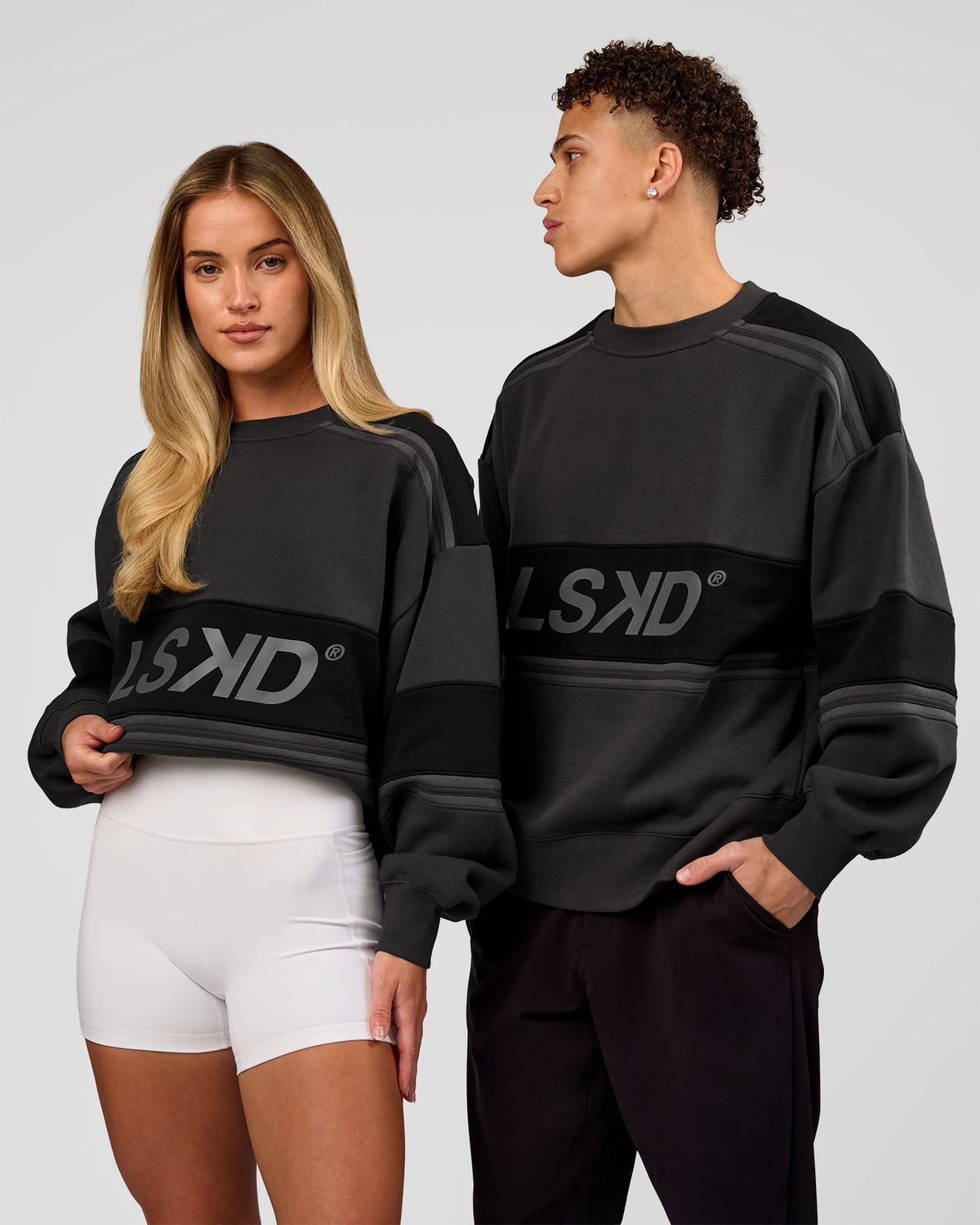 Duo wearing A-Team Sweater Oversize - Onyx-Black | Model:Issy | Size:XS | Model:Leandro | Size:M - view 1
