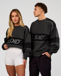 Duo wearing A-Team Sweater Oversize - Onyx-Black | Model:Issy | Size:XS | Model:Leandro | Size:M | Thumbnail Index: 0