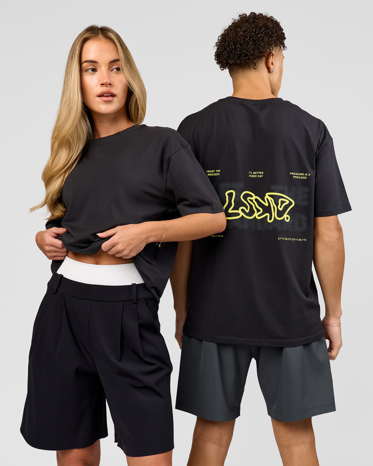 Duo wearing Benchmark FLXCotton Oversized Tee - Onyx-Yellow Fizz | Model:Issy | Size:XS | Model:Leandro | Size:M