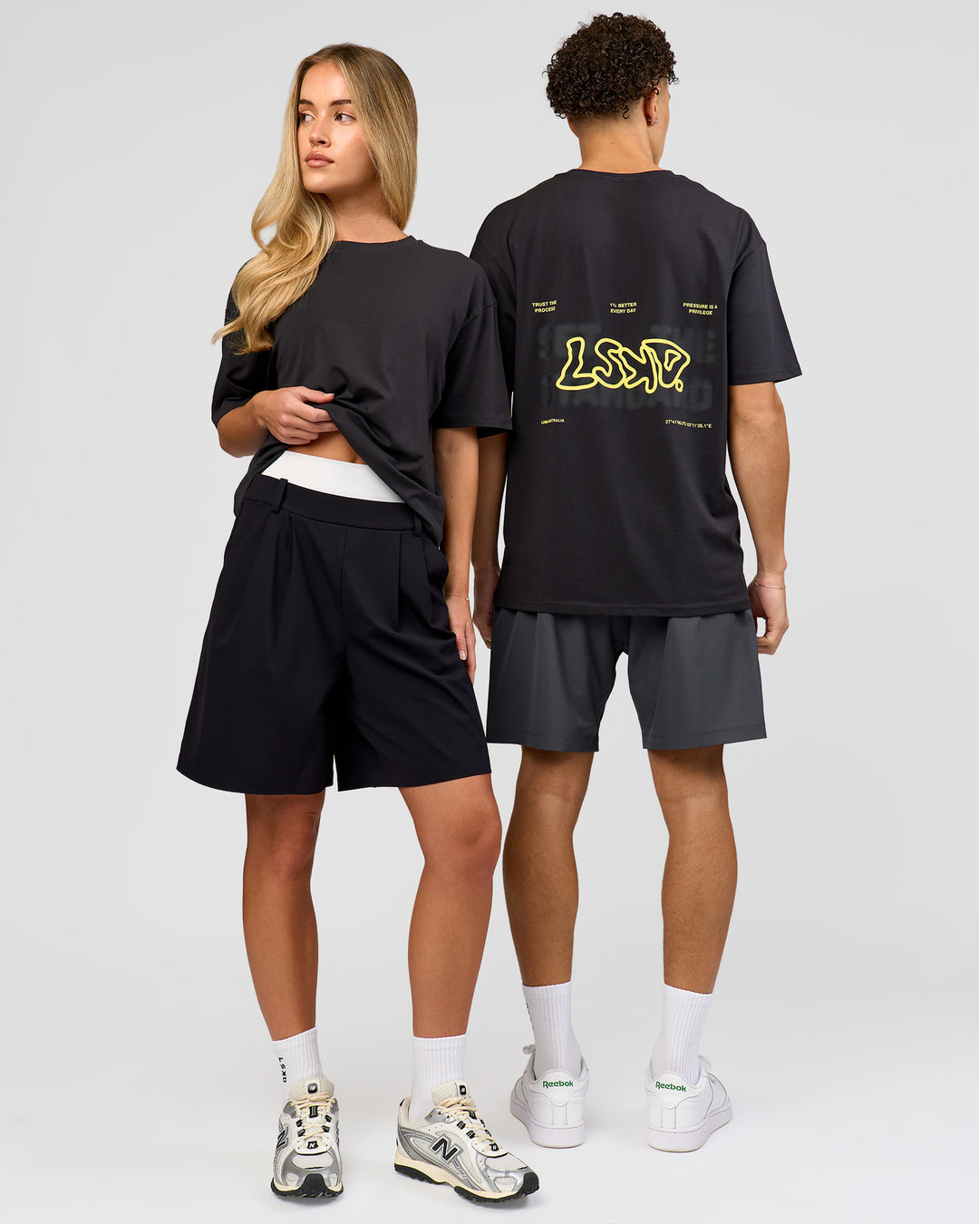 Duo wearing Benchmark FLXCotton Oversized Tee - Onyx-Yellow Fizz | Model:Issy | Size:XS | Model:Leandro | Size:M - view 3