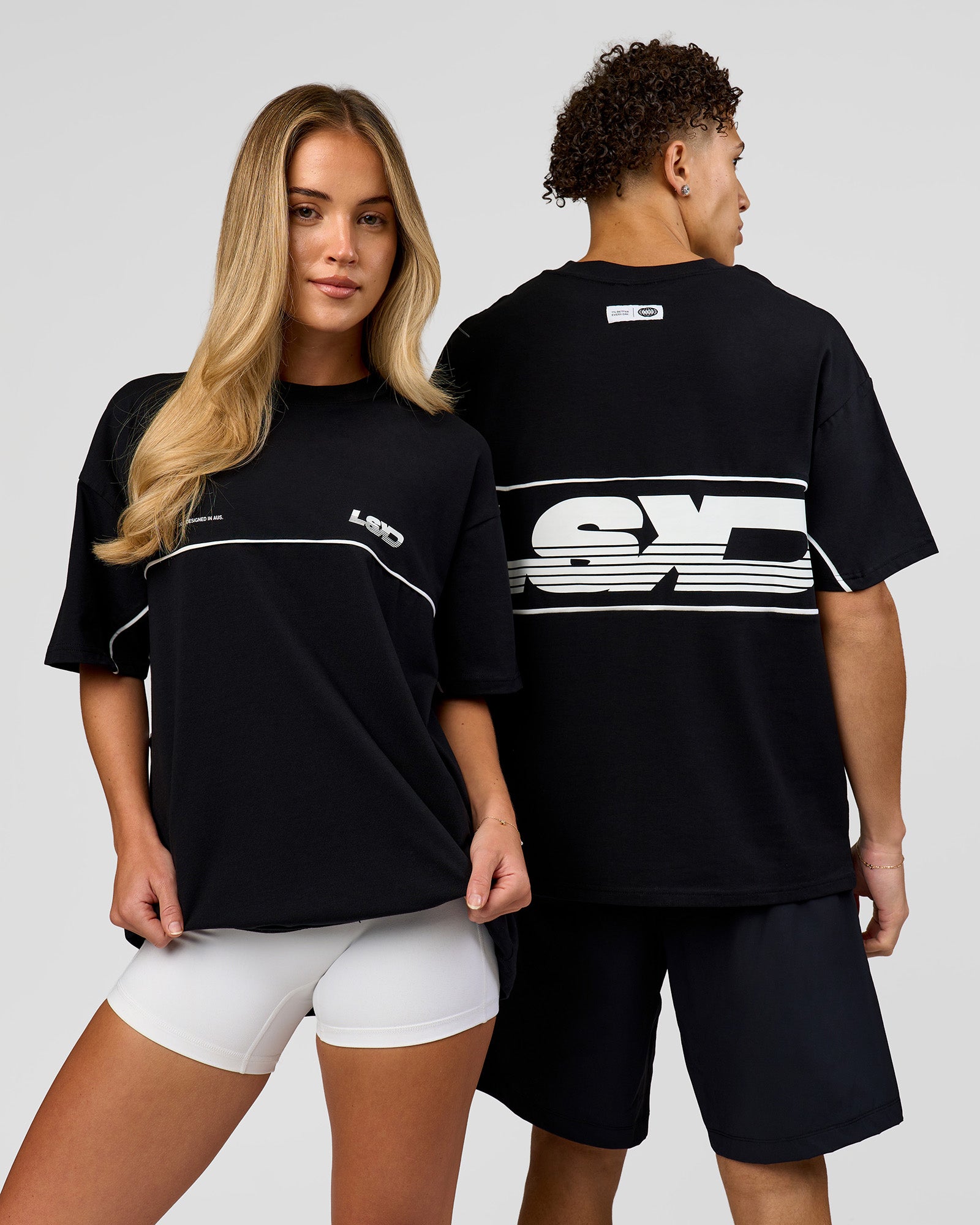 Duo wearing Inline Heavyweight FLXCotton Oversized Tee - Black-White | Model:Issy | Size:XS | Model:Leandro | Size:M