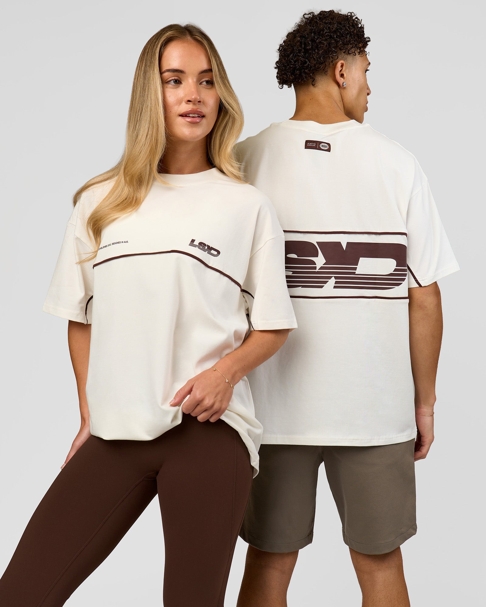 Duo wearing Inline Heavyweight FLXCotton Oversized Tee - Off White-Hot Chocolate | Model:Issy | Size:XS | Model:Leandro | Size:M