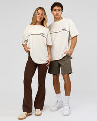 Duo wearing Inline Heavyweight FLXCotton Oversized Tee - Off White-Hot Chocolate | Model:Issy | Size:XS | Model:Leandro | Size:M | Thumbnail Index: 2