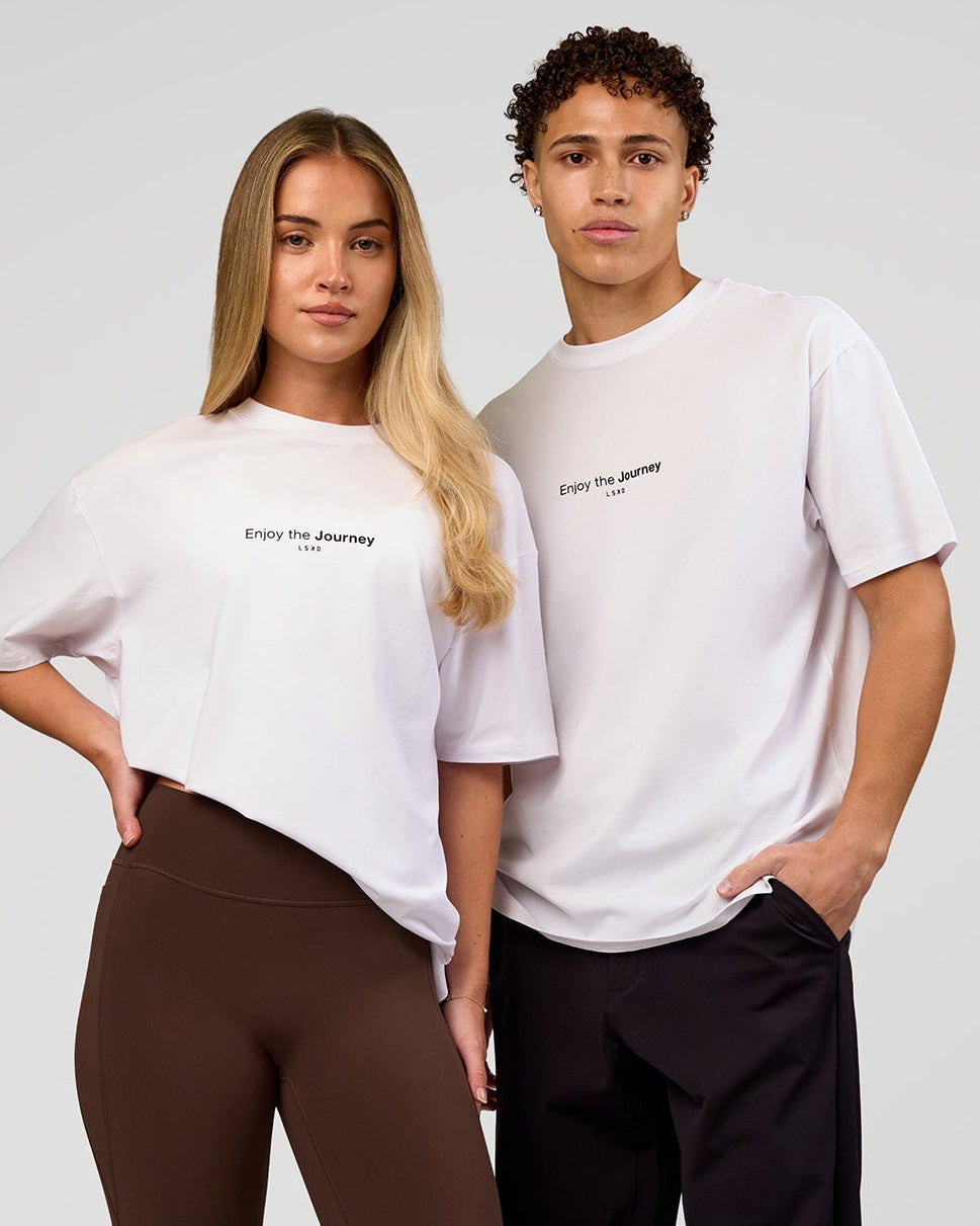 Duo wearing VS1 Enjoy The Journey FLXCotton Oversize Tee - White | Model:Issy | Size:XS | Model:Leandro | Size:M - view 1