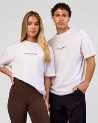 Duo wearing VS1 Enjoy The Journey FLXCotton Oversize Tee - White | Model:Issy | Size:XS | Model:Leandro | Size:M | Thumbnail Index: 0