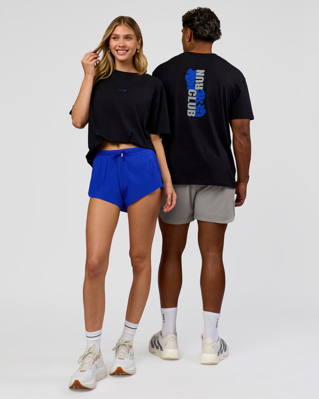 Duo wearing Run Club Elevate FLXCotton Oversized Tee - Black-Electric Indigo | Model:Leilani | Size:XS | Model:Xav | Size:L - view 2