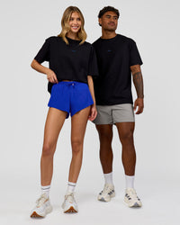 Duo wearing Run Club Elevate FLXCotton Oversized Tee - Black-Electric Indigo | Model:Leilani | Size:XS | Model:Xav | Size:L | Thumbnail Index: 6