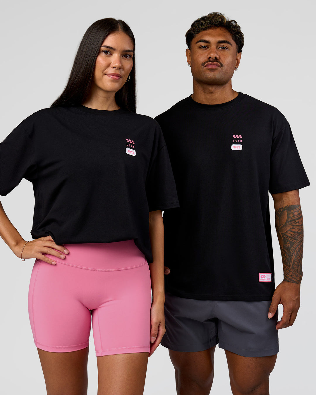Duo wearing Archive FLXCotton Oversized Tee - Black-Candy Pink | Model:Rhiley | Size:XS | Model:Xav | Size:L - view 4