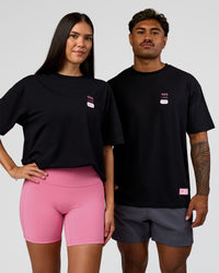 Duo wearing Archive FLXCotton Oversized Tee - Black-Candy Pink | Model:Rhiley | Size:XS | Model:Xav | Size:L | Thumbnail Index: 3