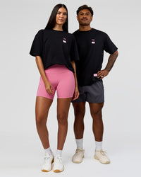 Duo wearing Archive FLXCotton Oversized Tee - Black-Candy Pink | Model:Rhiley | Size:XS | Model:Xav | Size:L | Thumbnail Index: 6