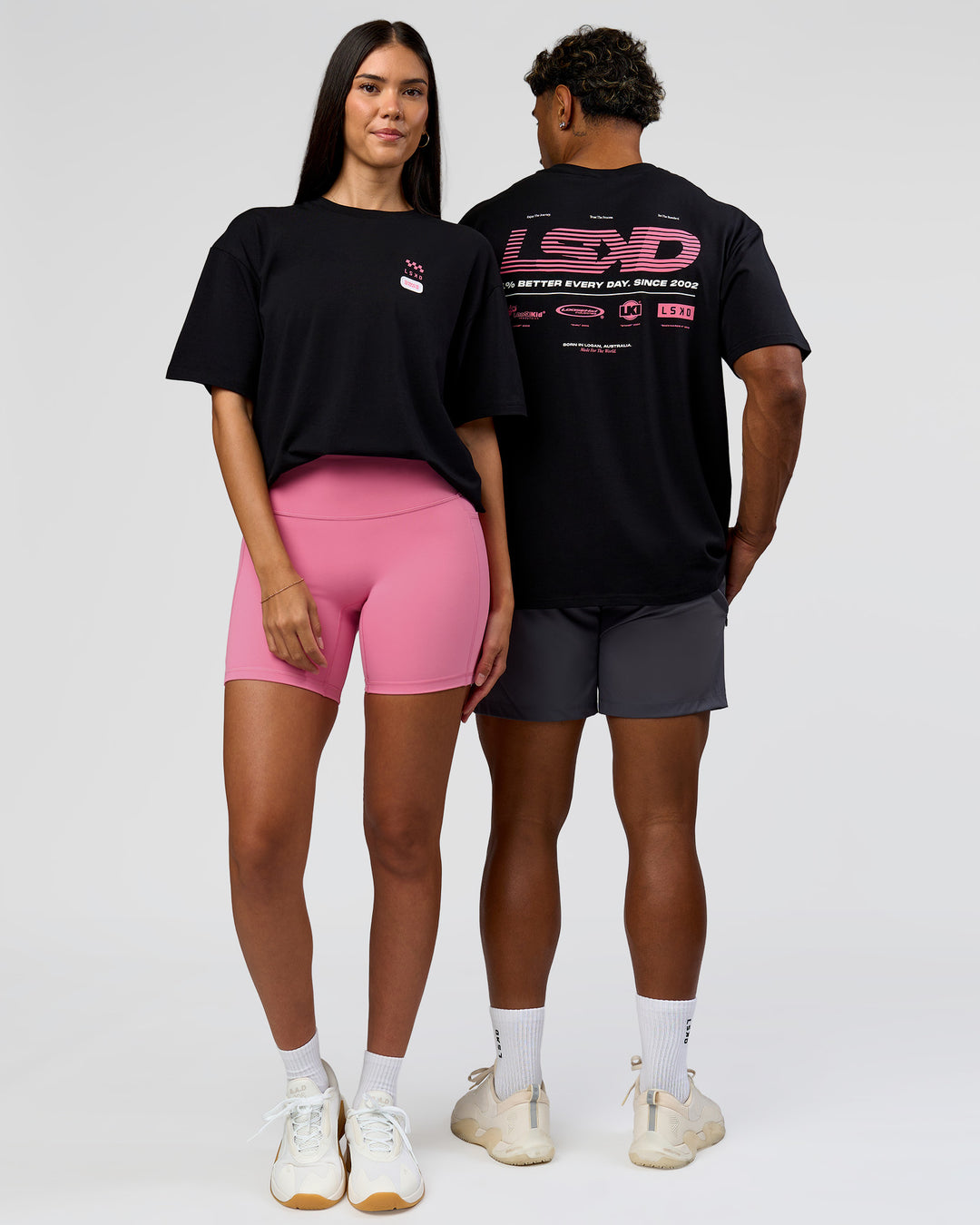 Duo wearing Archive FLXCotton Oversized Tee - Black-Candy Pink | Model:Rhiley | Size:XS | Model:Xav | Size:L - view 10