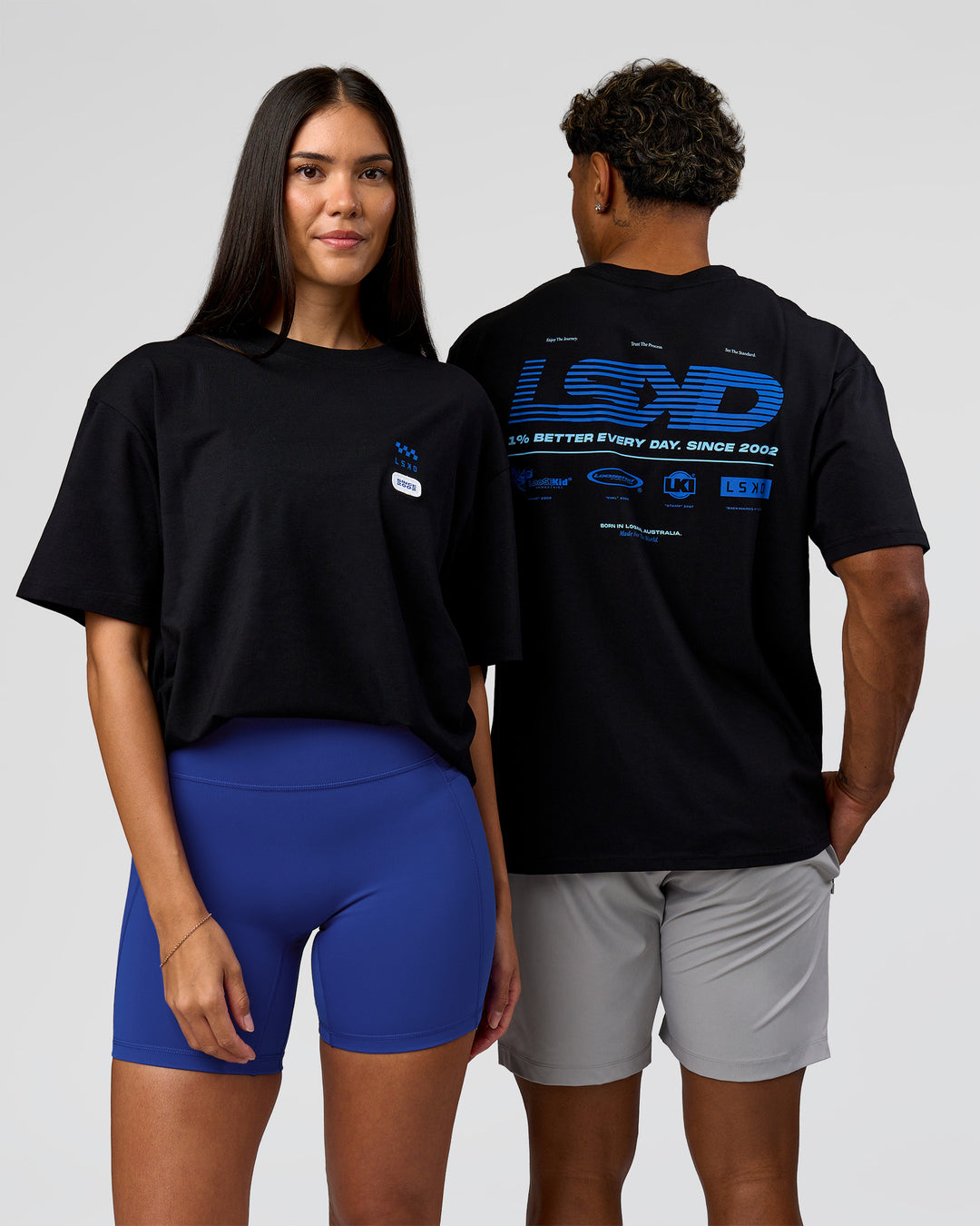 Duo wearing Archive FLXCotton Oversized Tee - Black-Electric Indigo | Model:Rhiley | Size:XS | Model:Xav | Size:L - view 1