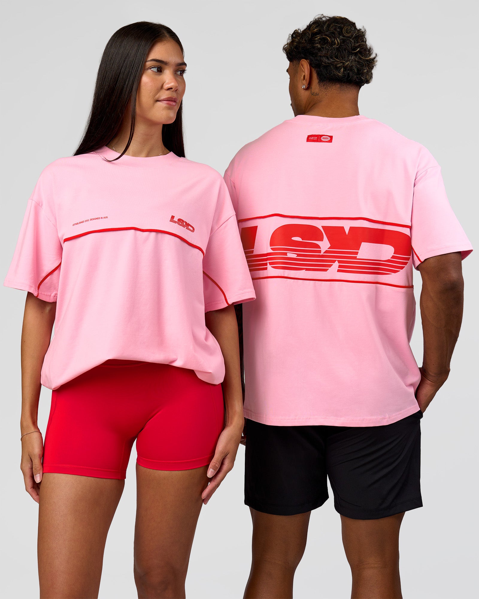 Duo wearing Inline Heavyweight FLXCotton Oversized Tee - Pink Rose-Flame | Model:Rhiley | Size:XS | Model:Xav | Size:L