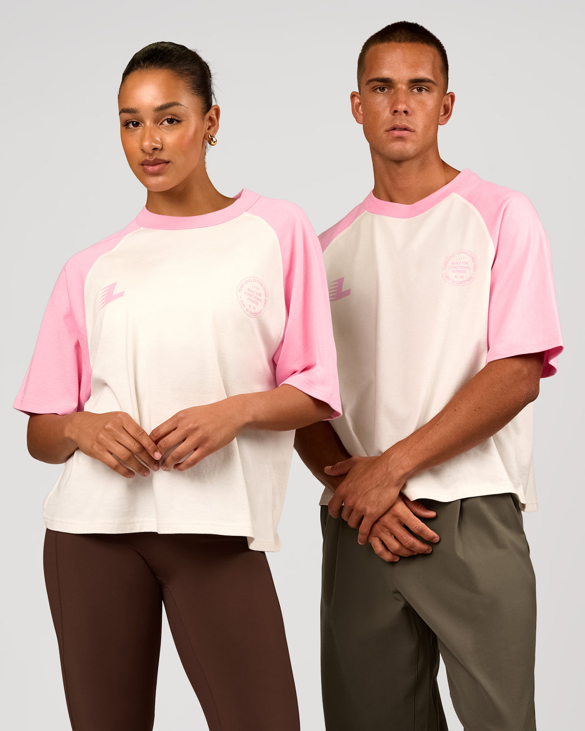 Duo wearing Victory Heavyweight Boxed Raglan Tee - Off White-Pink Rose | Model:Rosie | Size:XS | Model:Albert | Size:M