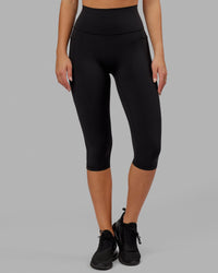 Woman wearing O.G. Fusion Ultra High-Rise 3/4 Legging Pockets - Black | Model:Milly | Size:S | Thumbnail Index: 6
