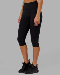 Woman wearing O.G. Fusion Ultra High-Rise 3/4 Legging Pockets - Black | Model:Milly | Size:S | Thumbnail Index: 0