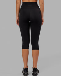 Woman wearing O.G. Fusion Ultra High-Rise 3/4 Legging Pockets - Black | Model:Milly | Size:S | Thumbnail Index: 2