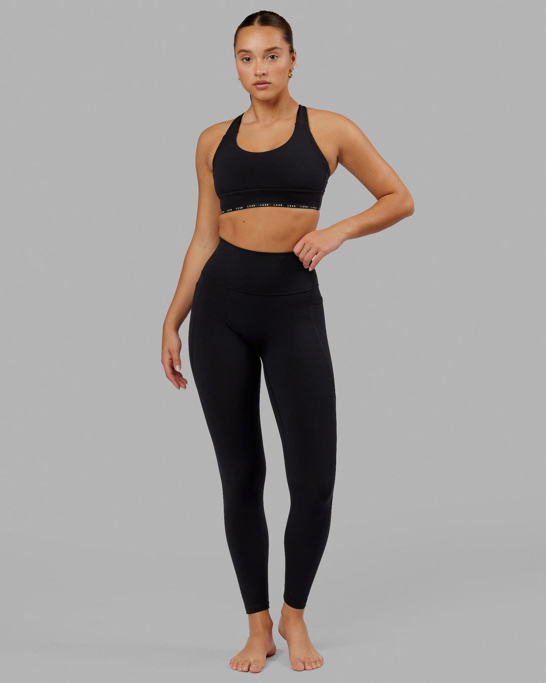 Woman wearing O.G. Fusion Ultra High-Rise Full Length Legging Pockets - Black | Model:Milly | Size:S - view 1