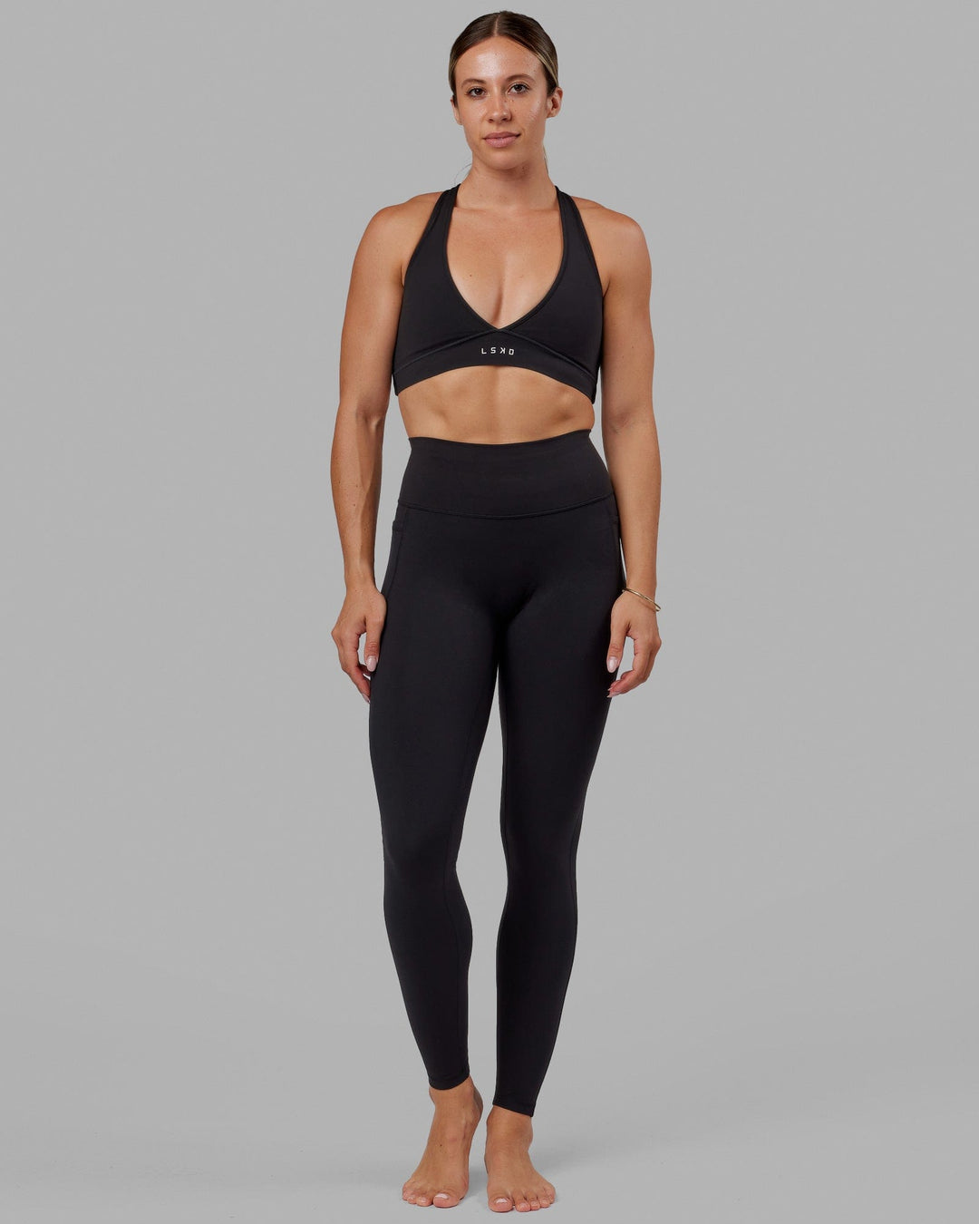 Woman wearing O.G. Fusion Ultra High-Rise Tall Legging Pockets - Black | Model:Bree | Size:S - view 1