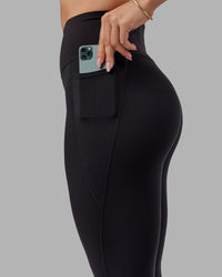 Woman wearing O.G. Fusion Ultra High-Rise Tall Legging Pockets - Black | Model:Bree | Size:S | Thumbnail Index: 1