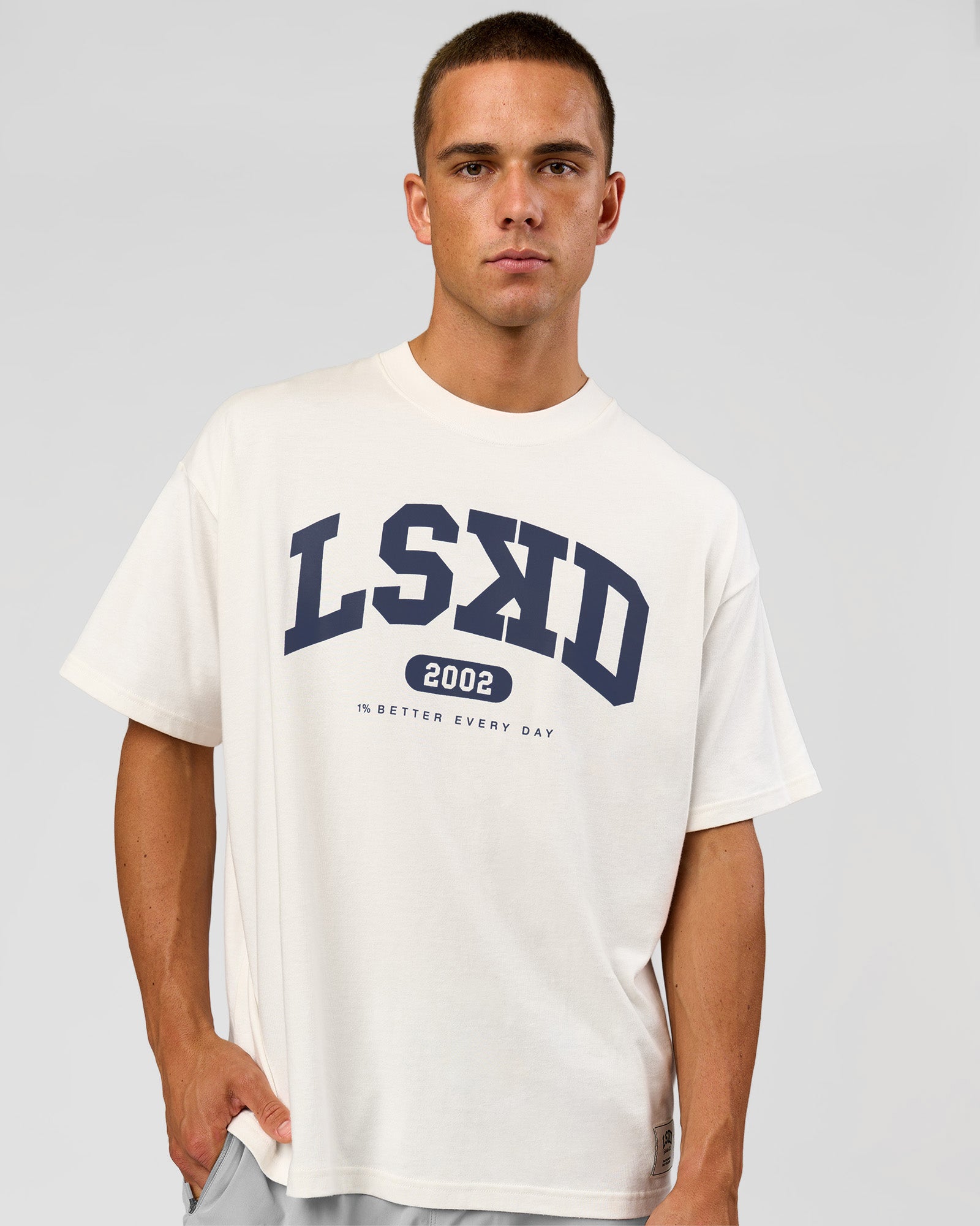 Man wearing Varsity EST Heavyweight Oversized Tee  - Off White-Future Navy | Model:Albert | Size:L