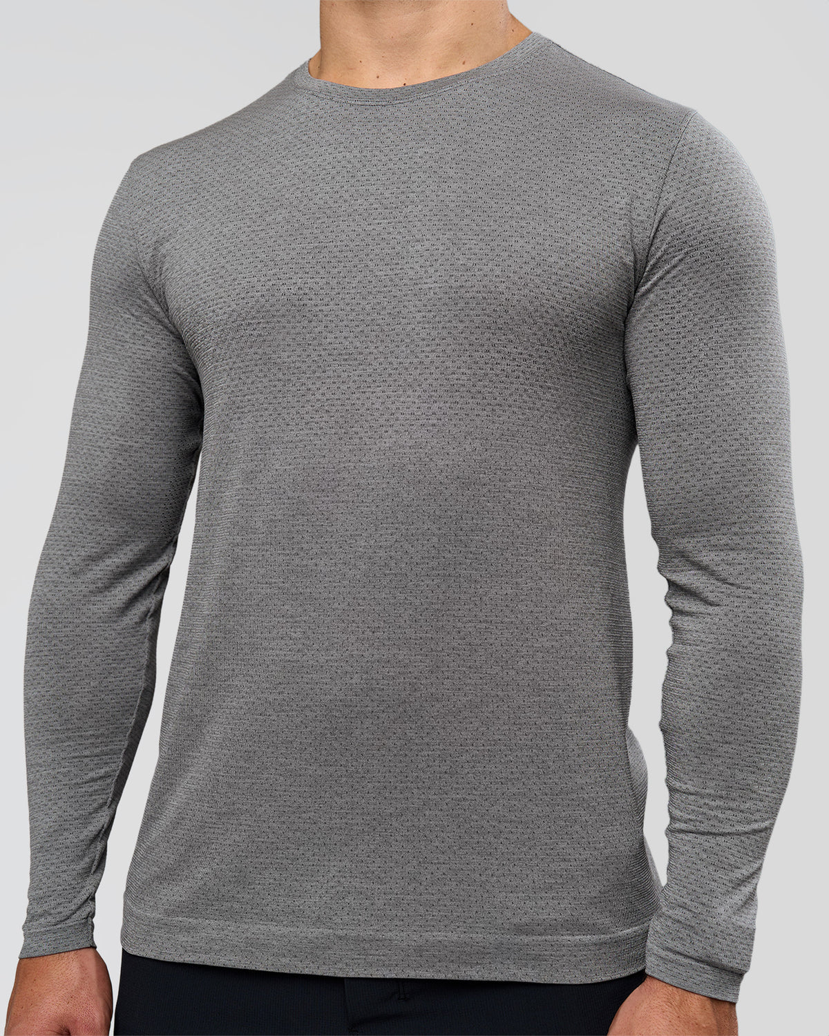 Man wearing AeroFLX+ Seamless Long Sleeve Tee (Set in Sleeve) - Dark Storm/Alloy | Model:Jaiden | Size:L