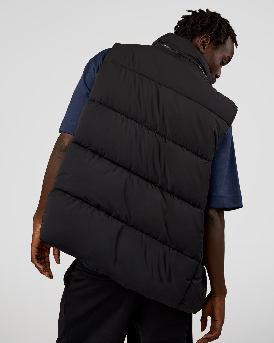 Man wearing Base Puffer Vest - Black | Model:Okello | Size:L - view 2