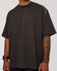 Man wearing AfterDark ZeroCrease Oversized Tee - Onyx | Model:Xav | Size:L | Thumbnail Index: 1
