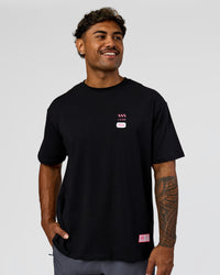 Man wearing Archive FLXCotton Oversized Tee - Black-Candy Pink | Model:Xav | Size:L | Thumbnail Index: 4