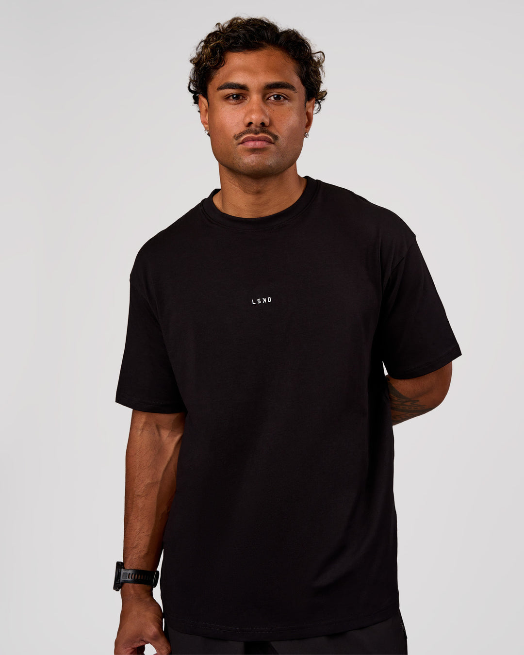 Man wearing Base FLXCotton Tee Oversized - Black | Model:Xav | Size:L - view 1