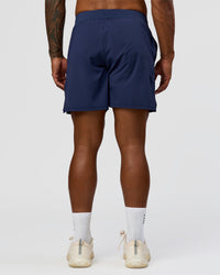 Man wearing Greatest of All Time Functional Training 7" Short - Future Navy-White | Model:Xav | Size:L | Thumbnail Index: 7