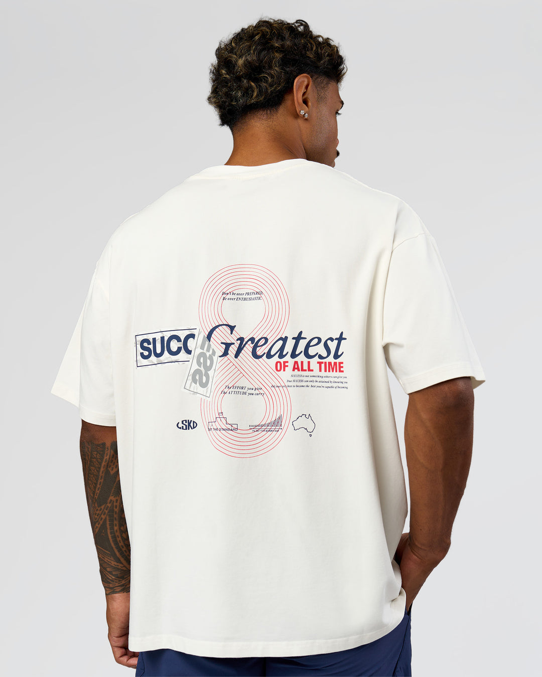 Man wearing Greatest of All Time Heavyweight FLXCotton Oversized Tee - Off White Washed-Scarlet | Model:Xav | Size:L - view 4