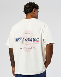Man wearing Greatest of All Time Heavyweight FLXCotton Oversized Tee - Off White Washed-Scarlet | Model:Xav | Size:L | Thumbnail Index: 3