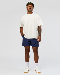 Man wearing Greatest of All Time Heavyweight FLXCotton Oversized Tee - Off White Washed-Scarlet | Model:Xav | Size:L | Thumbnail Index: 17