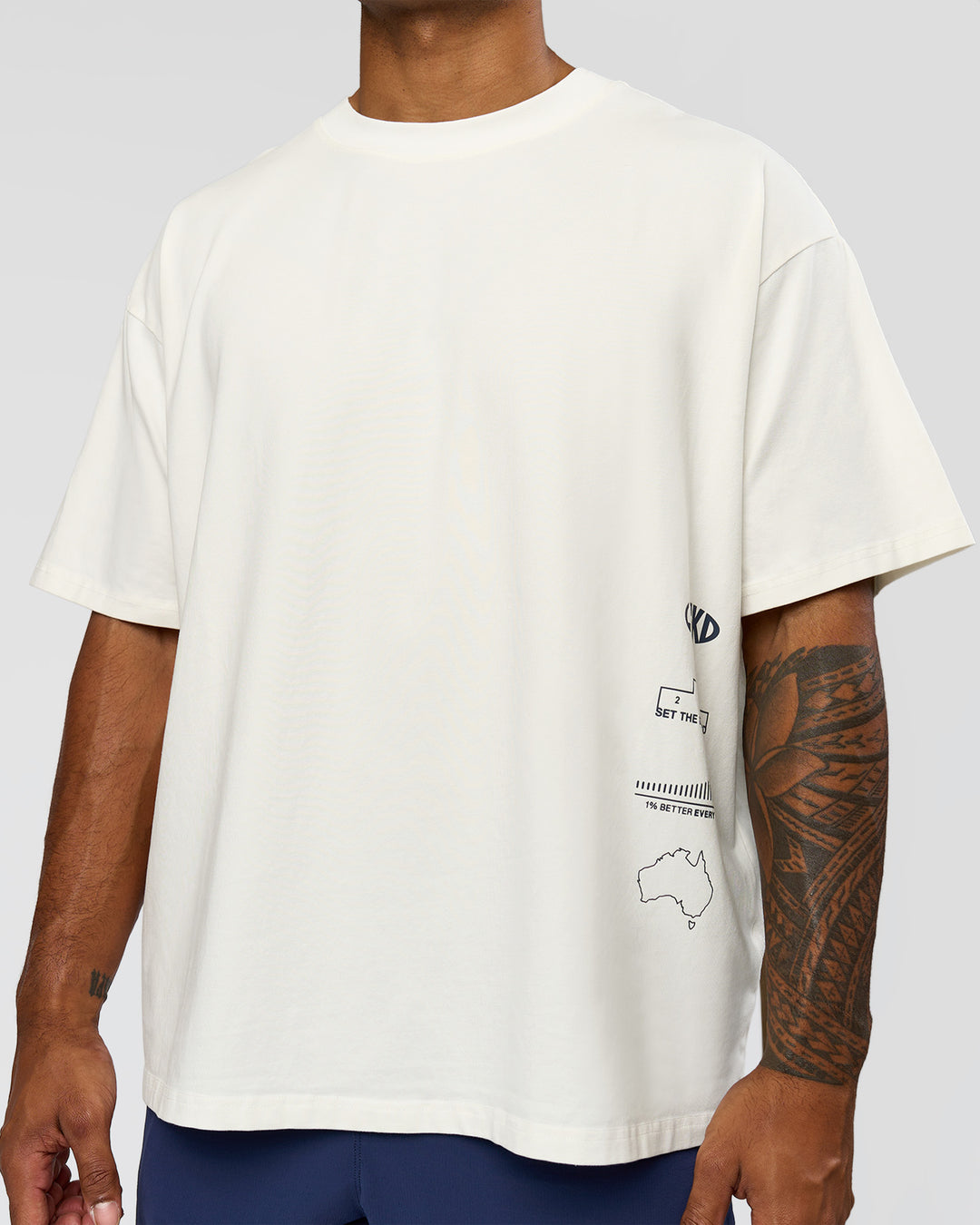 Man wearing Greatest of All Time Heavyweight FLXCotton Oversized Tee - Off White Washed-Scarlet | Model:Xav | Size:L - view 5