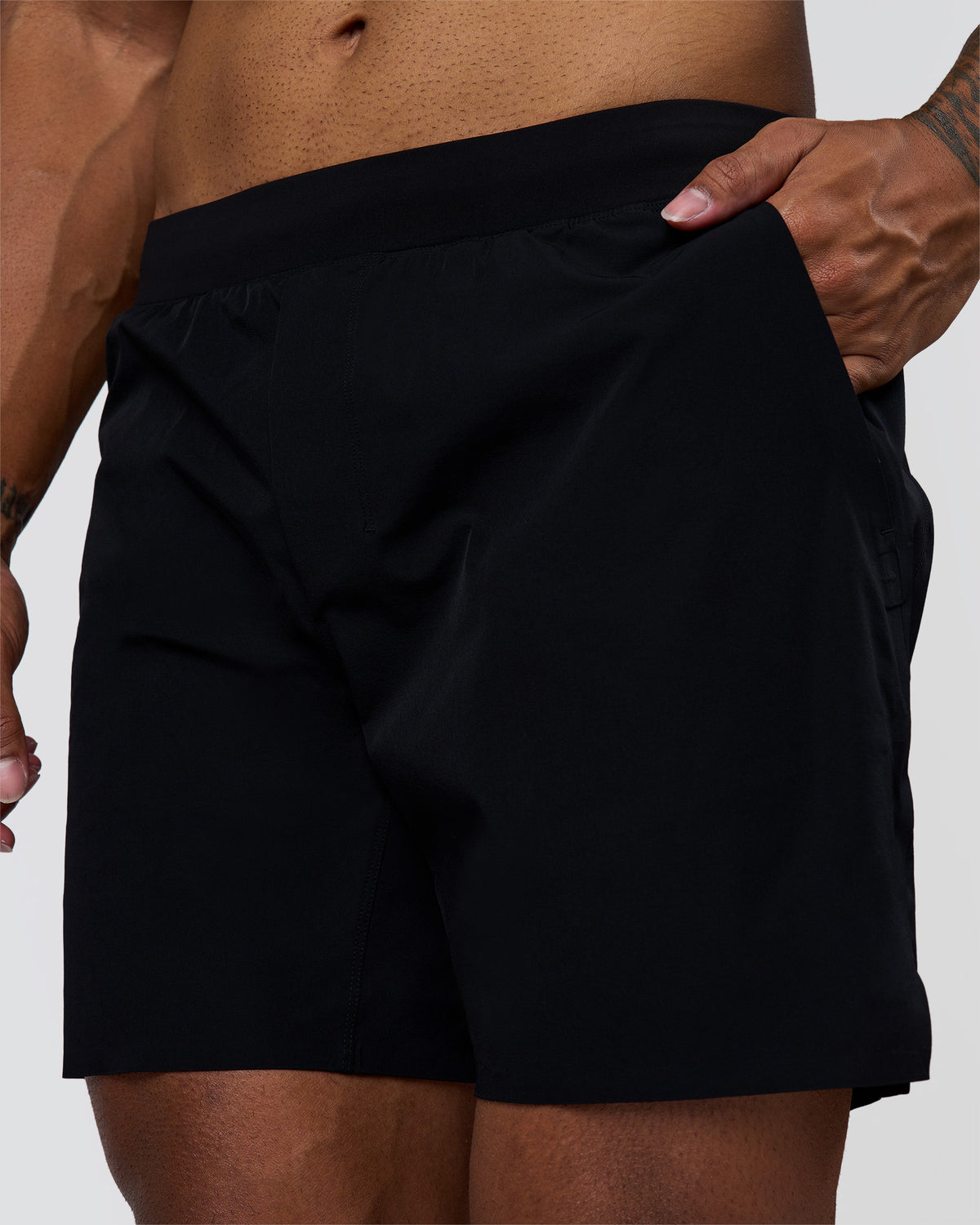 Man wearing Hybrid Lined 7" Short - Black | Model:Xav | Size:L
