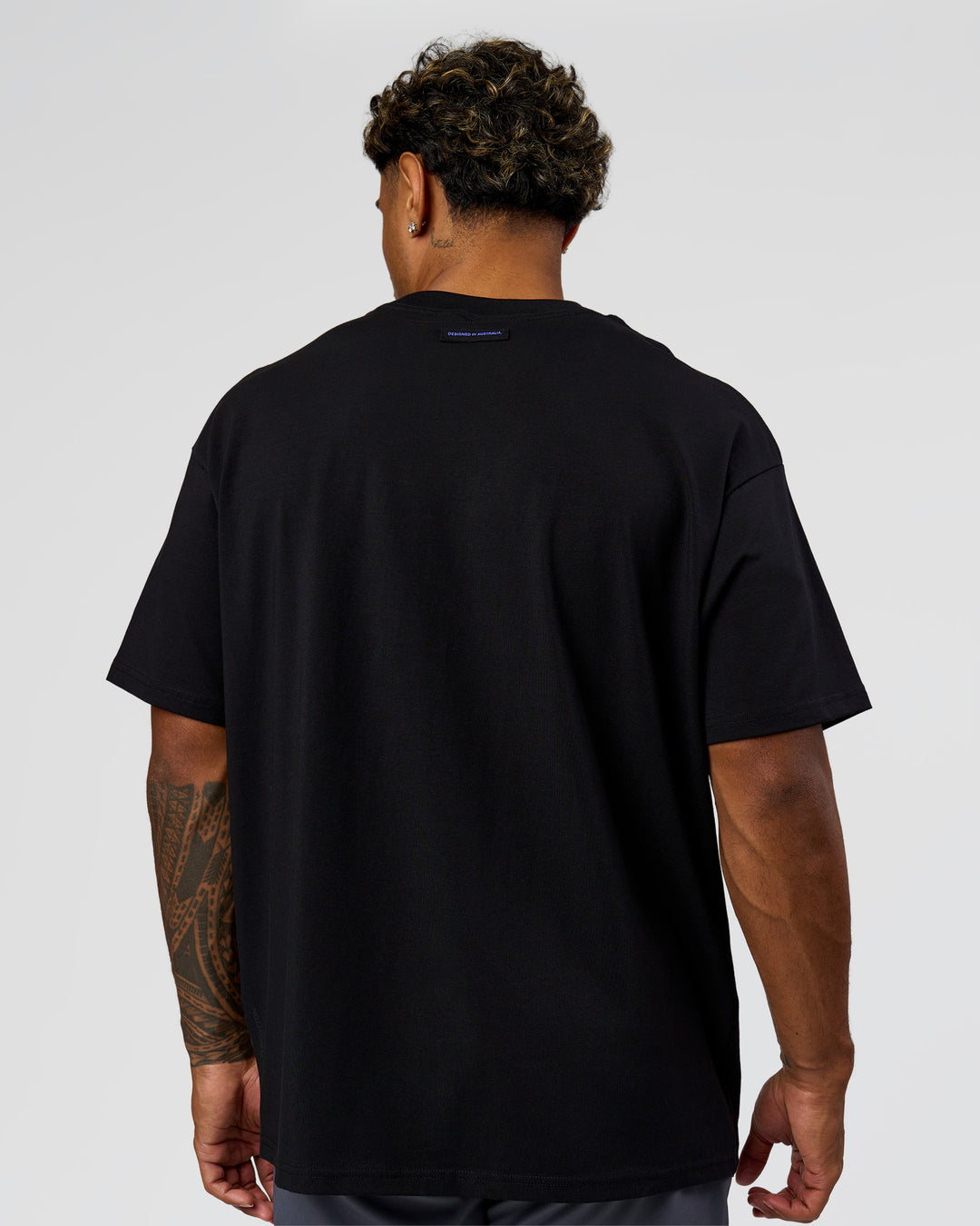 Man wearing League Heavyweight FLXCotton Oversized Tee - Black-Power Cobalt | Model:Xav | Size:L - view 17