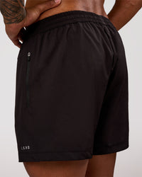 Man wearing Rep 5" Performance Short - Black | Model:Xav | Size:L | Thumbnail Index: 1