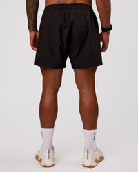 Man wearing Rep 5" Performance Short - Black | Model:Xav | Size:L | Thumbnail Index: 3