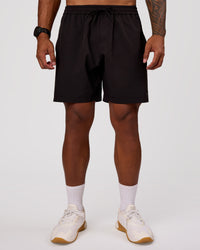 Man wearing Rep 7" Performance Short - Black-White | Model:Xav | Size:L | Thumbnail Index: 1