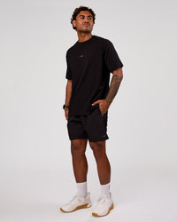 Man wearing Rep 7" Performance Short - Black-White | Model:Xav | Size:L | Thumbnail Index: 3