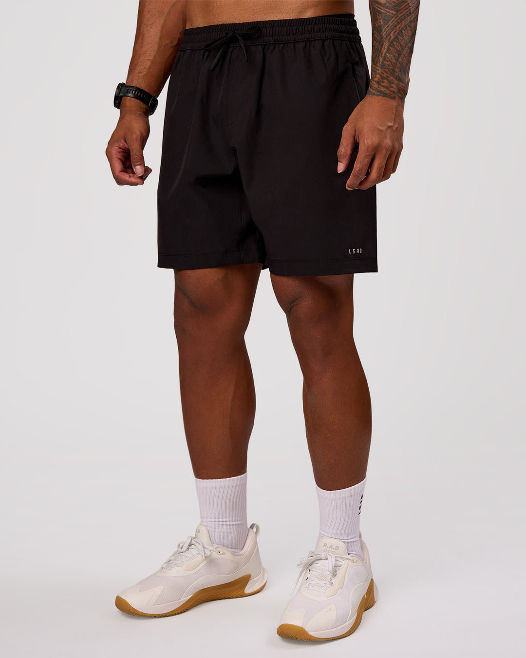 Man wearing Rep 7" Performance Short - Black-White | Model:Xav | Size:L - view 5