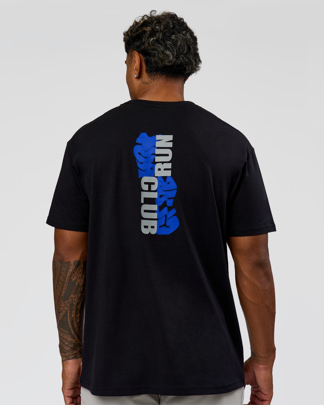 Man wearing Run Club Elevate FLXCotton Oversized Tee - Black-Electric Indigo | Model:Xav | Size:L - view 3