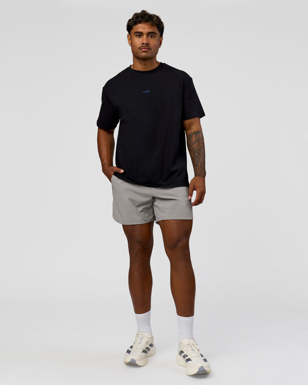 Man wearing Run Club Elevate FLXCotton Oversized Tee - Black-Electric Indigo | Model:Xav | Size:L - view 5