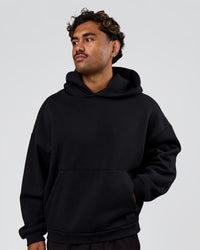 Man wearing Tonal Legacy Boxy Hoodie - Black-Black | Model:Xav | Size:L | Thumbnail Index: 4