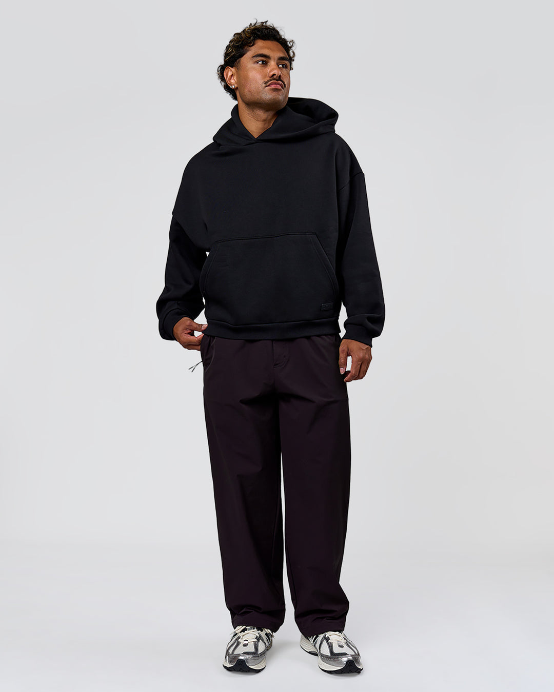 Man wearing Tonal Legacy Boxy Hoodie - Black-Black | Model:Xav | Size:L - view 8