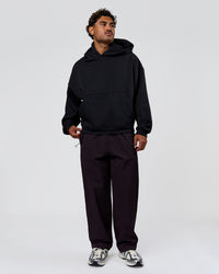 Man wearing Tonal Legacy Boxy Hoodie - Black-Black | Model:Xav | Size:L | Thumbnail Index: 7
