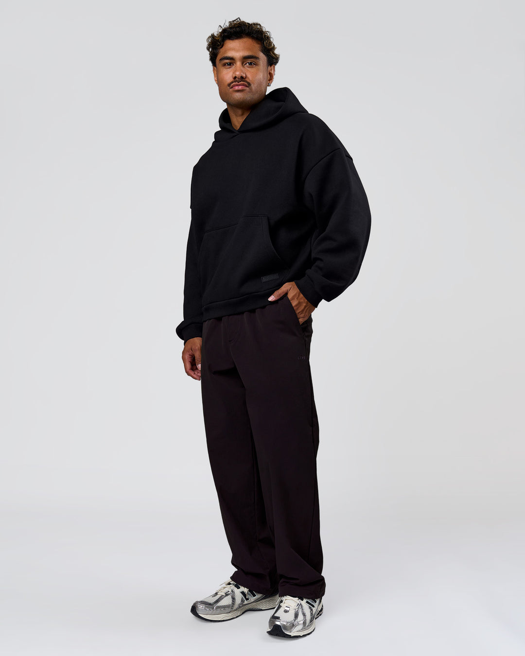 Man wearing Tonal Legacy Boxy Hoodie - Black-Black | Model:Xav | Size:L - view 10