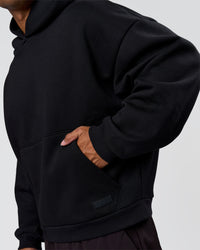 Man wearing Tonal Legacy Boxy Hoodie - Black-Black | Model:Xav | Size:L | Thumbnail Index: 13
