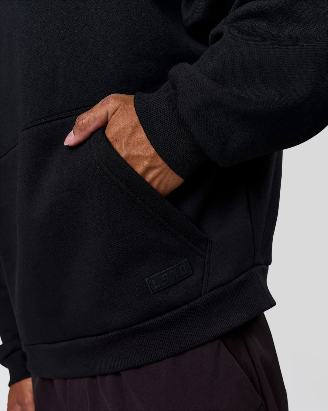 Man wearing Tonal Legacy Boxy Hoodie - Black-Black | Model:Xav | Size:L - view 16